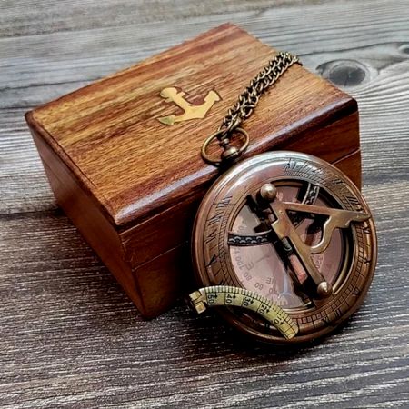 Brass Pocket Compass Displayed on Wooden Box